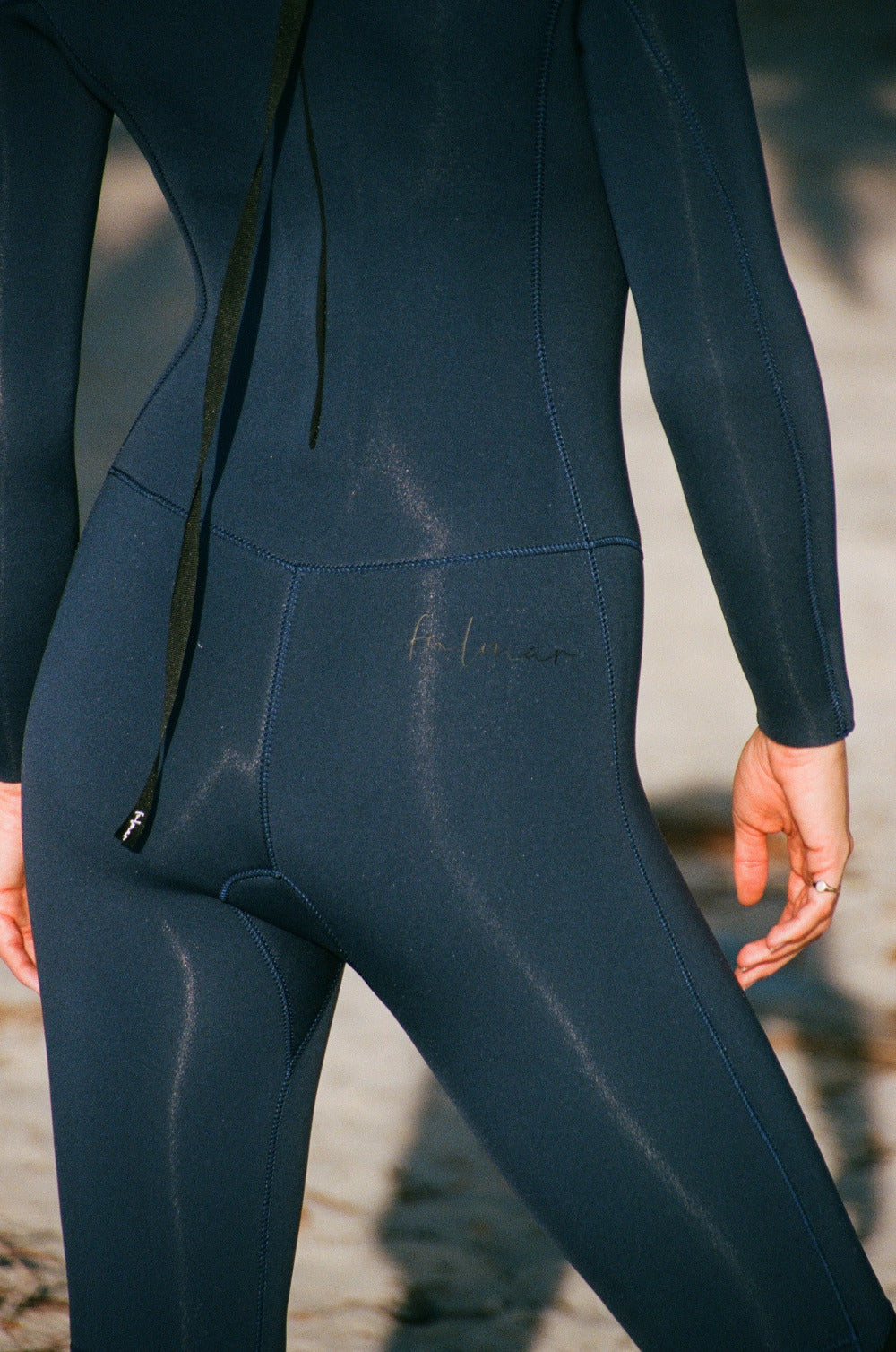 Close-up of a dark blue wetsuit on a blurred natural background